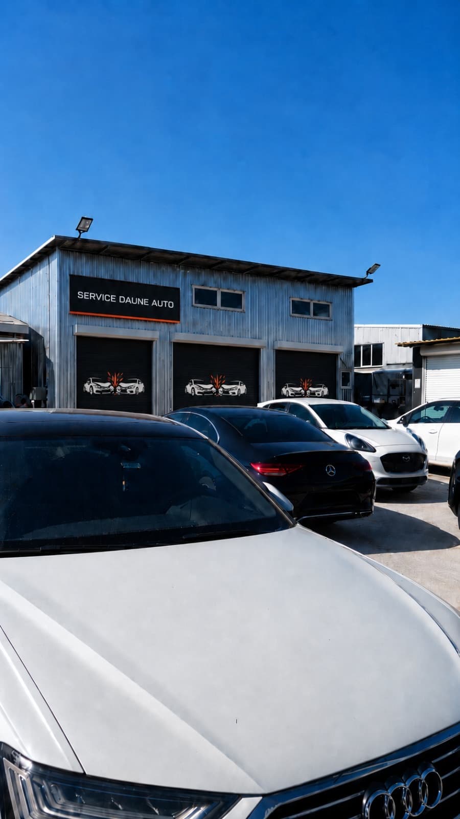 Atelierul Service Daune Auto din Bragadiru — fațada cu firma și mașini ale clienților în lucru