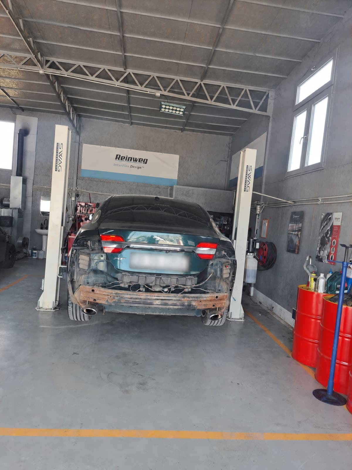 Jaguar XF pe elevator, cu bara spate demontată, în reparație la service auto daune Bragadiru